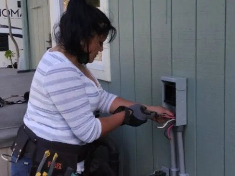 Licensed electrician wiring an exterior subpanel in University of California-Davis